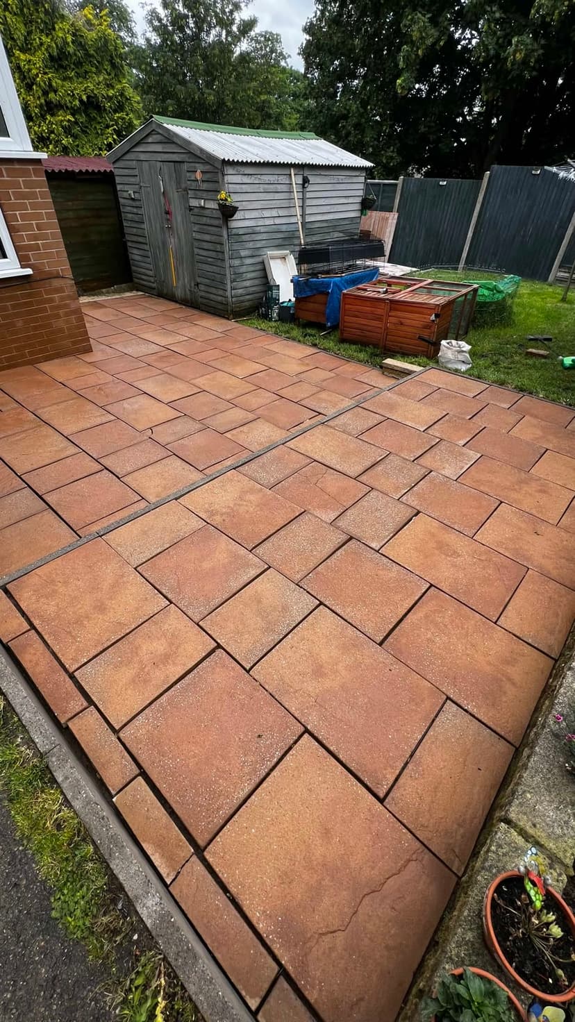 Concrete slab patio after — moss and weathering gone, the warm tone back.