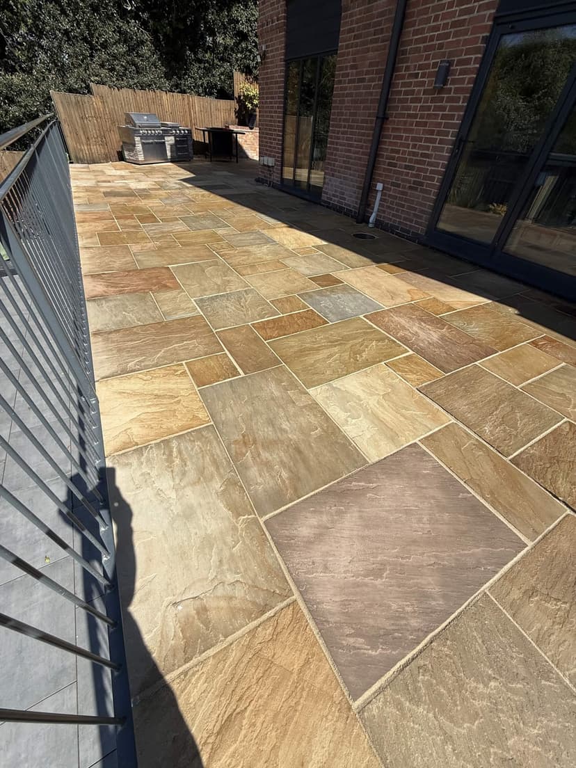Riven sandstone patio finished in the sun, an even tone across every slab.